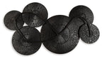 Black and gold wall decor featuring overlapping round metal disc set with radial fans