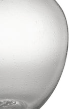 Close-up of speckled clear glass vase body with narrow neck and glossy finish.