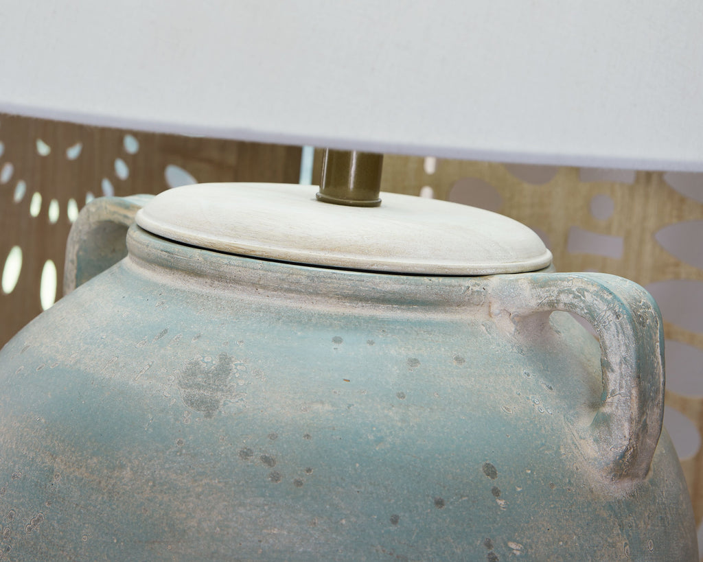 Table lamp with white drum shade and antique green ceramic lid on vase base