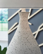 Speckled white metal lamp base with narrow neck and finial