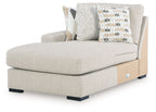 Light upholstered chaise with squared arm, black legs, and decorative checkered and solid pillows