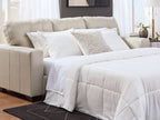 Santorine beige sofa sleeper with pull-out bed and white bedding, side view