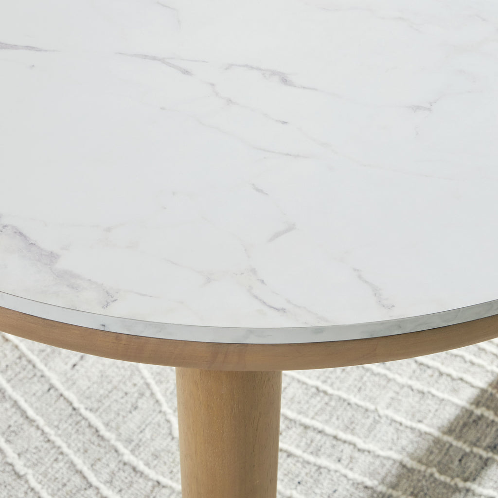 Edge of round dining table: light gray marble-look surface with light brown wooden rim