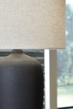 Beige drum lampshade and dark metal base with textured finish