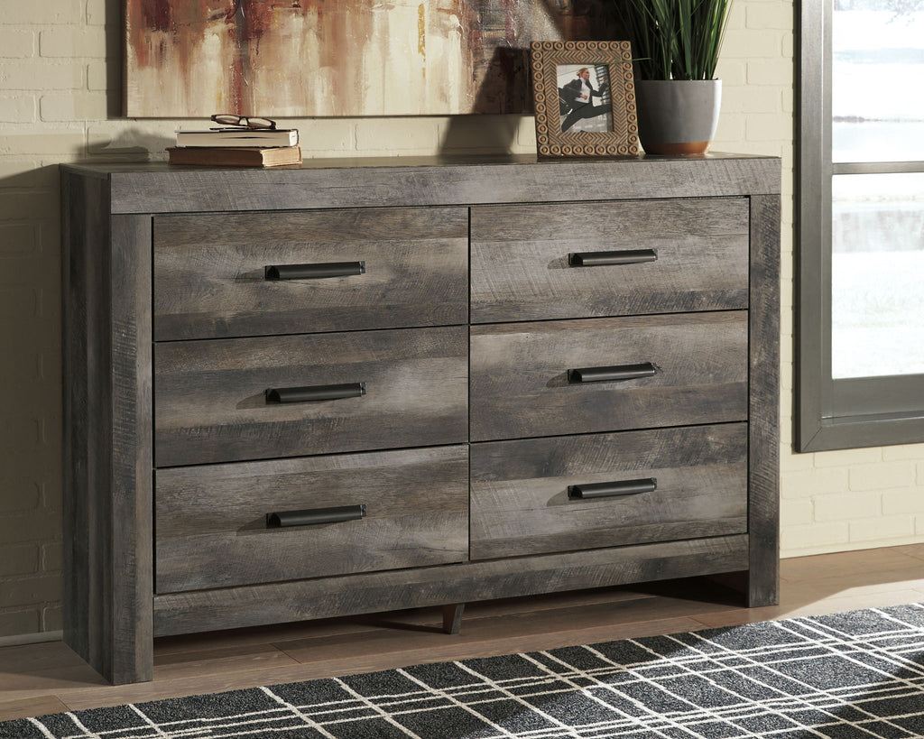 Gray wood dresser with four drawers and black bar pulls