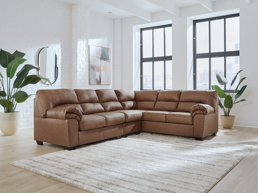 Brown sectional sofa with tufted cushions and rounded arms