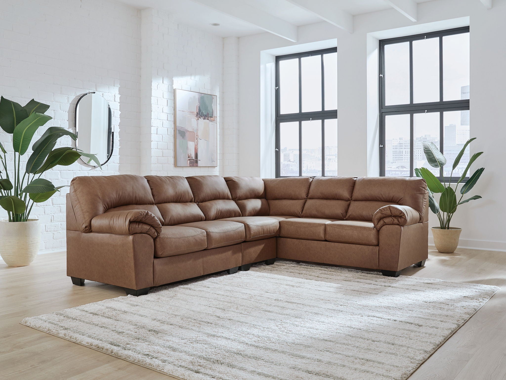 Brown sectional sofa with tufted cushions and rounded arms