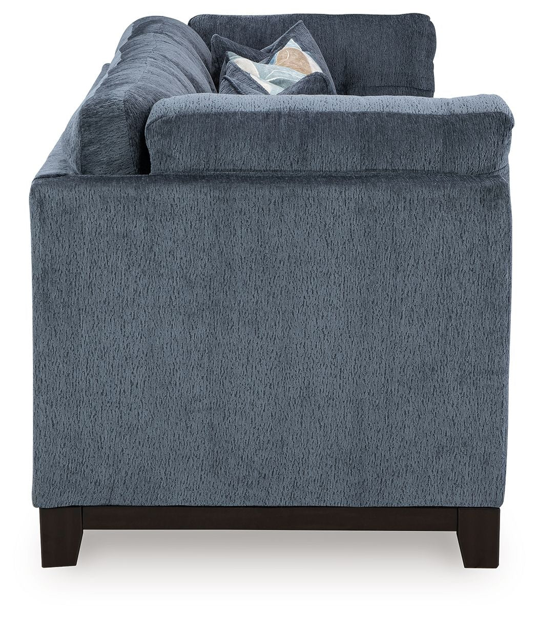 Navy fabric sofa with broad arms and visible cushions