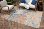 5' x 7' greige area rug with faded blue and orange distressed abstract design