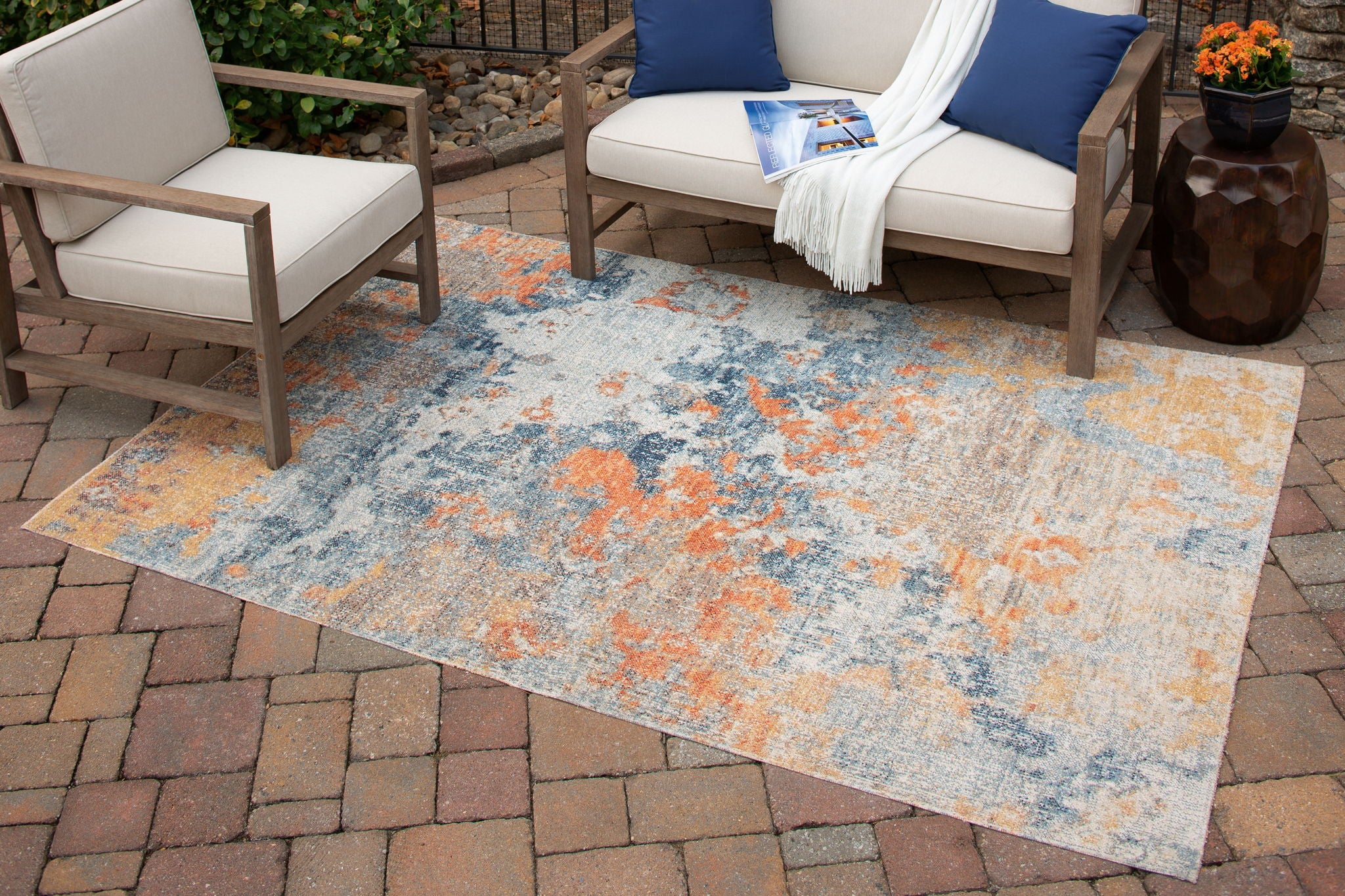5' x 7' greige area rug with faded blue and orange distressed abstract design