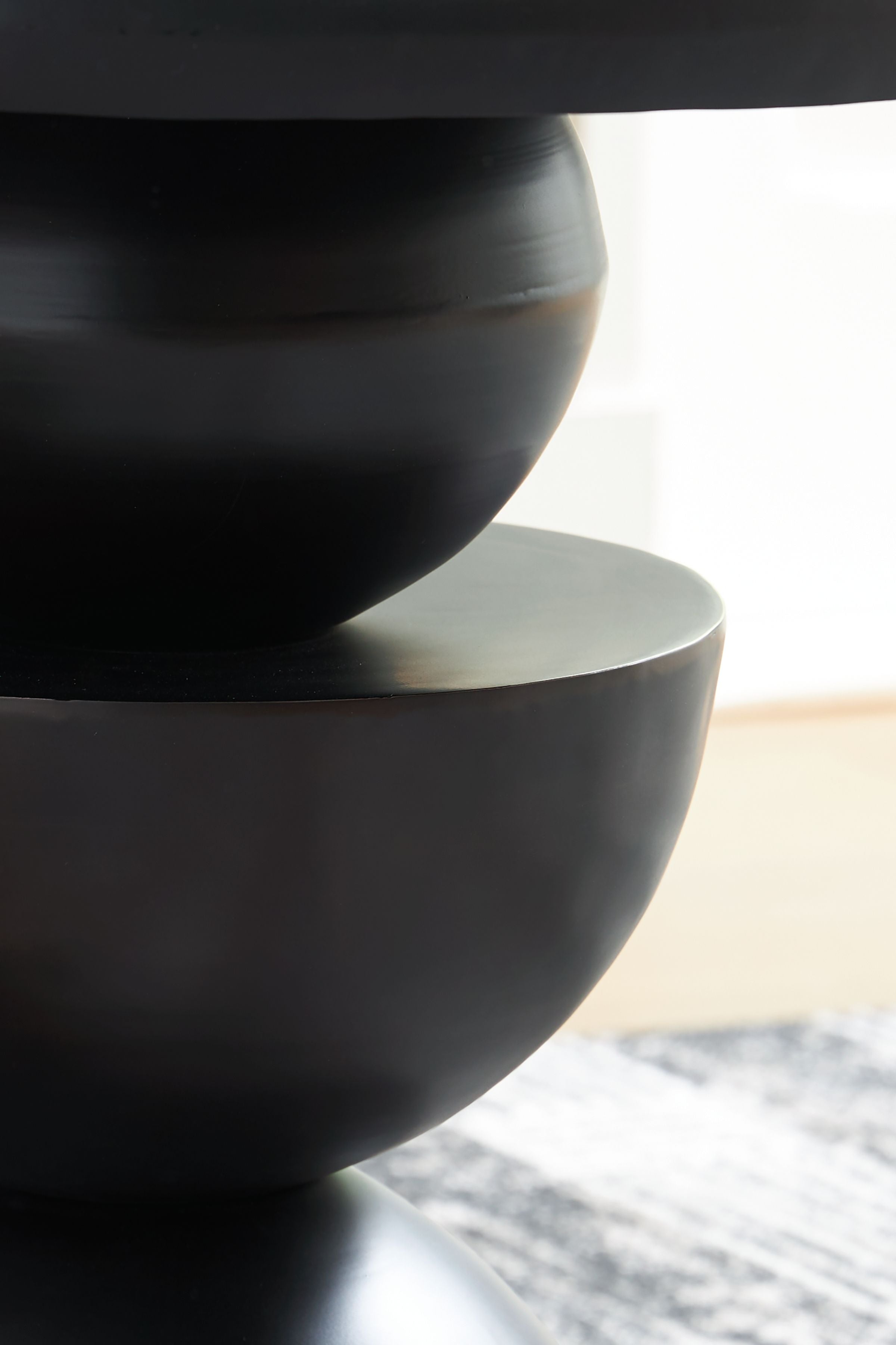 Bronze accent table, hourglass pedestal with dark satin finish, round top