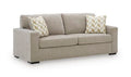 Bridgepoint light brown sofa with two back cushions and two patterned throw pillows
