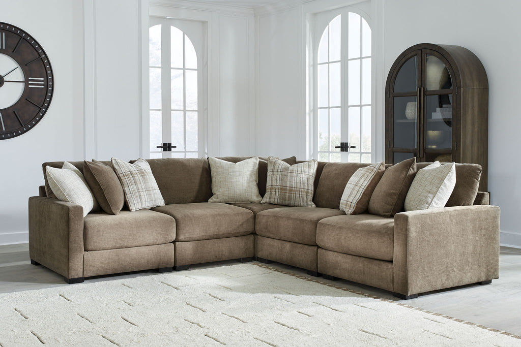 Coffee-brown sectional sofa with chaise end and back cushions, styled with throw pillows