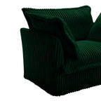 Green corduroy sectional chair with rounded arms and draped accent cushion