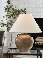 Antique beige poly table lamp with fabric drum shade and rounded base