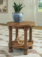 Round light brown wooden end table with lower shelf and turned legs