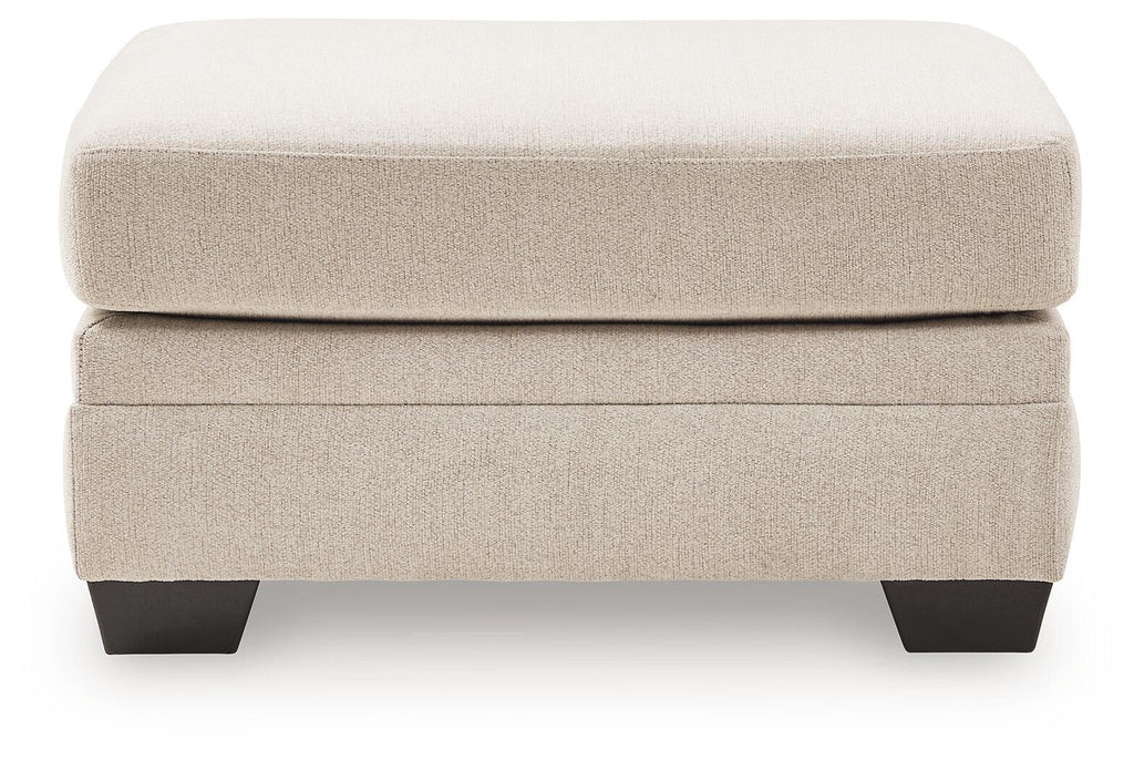 Beige upholstered ottoman with two-tier design and dark legs