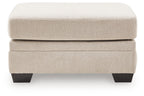 Beige upholstered ottoman with two-tier design and dark legs