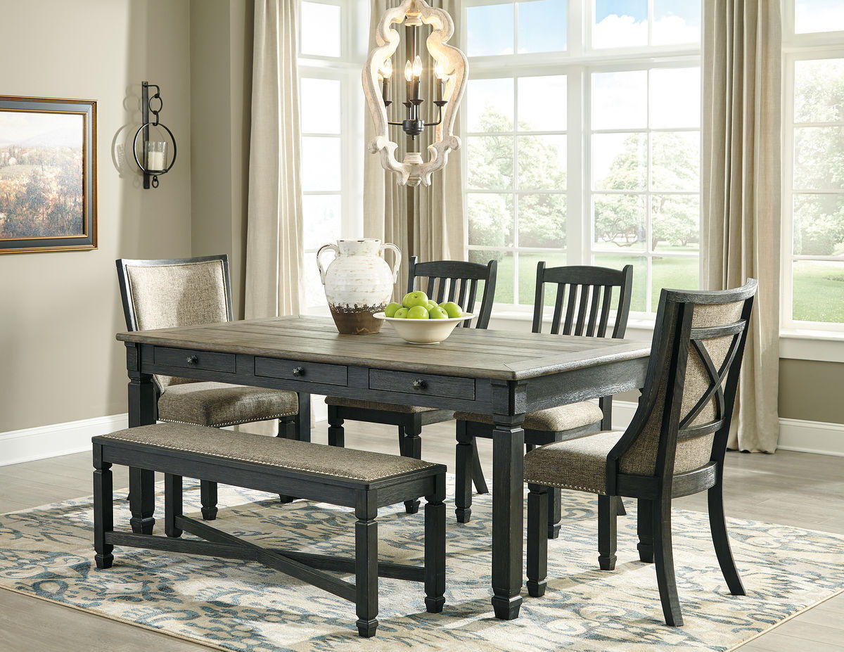 Dark gray dining table with two upholstered benches and four slat-back chairs