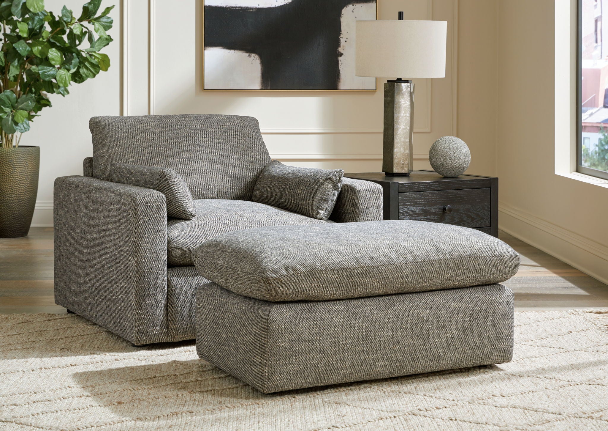 Gray fabric loveseat with two seat cushions and two matching back pillows