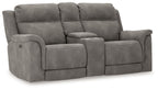 Dark gray reclining loveseat with padded arms, tufted back, and power recline