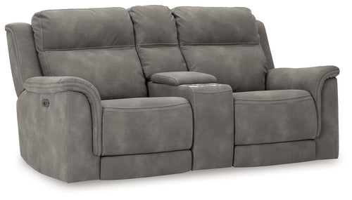 Dark gray reclining loveseat with padded arms, tufted back, and power recline