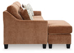 Brown sofa with chaise and matching ottoman, with patterned throw pillows