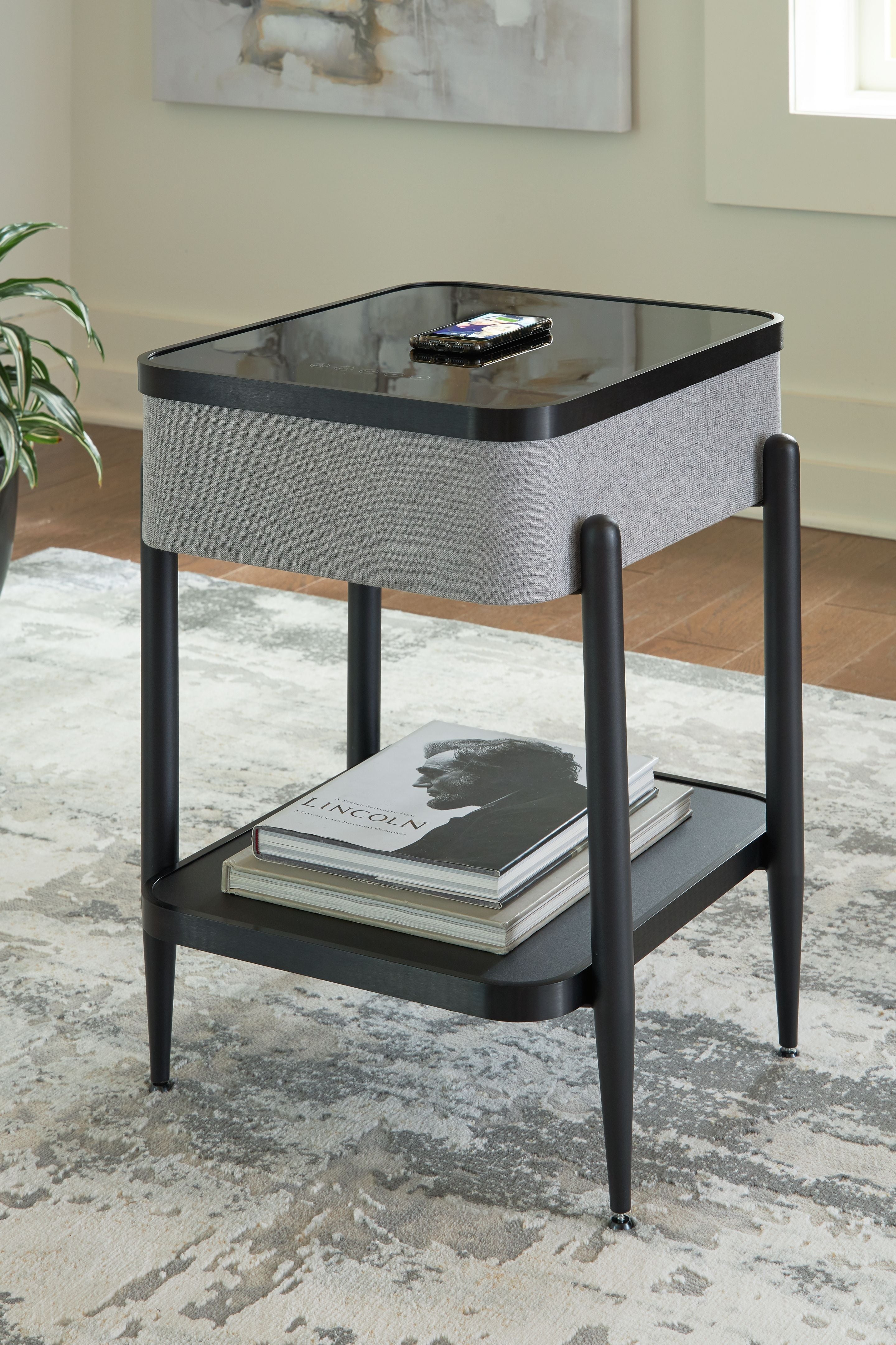 Gray speaker accent table with glossy black top and lower storage shelf