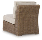 Beige armless chair with seat cushion and upright back, woven wicker frame
