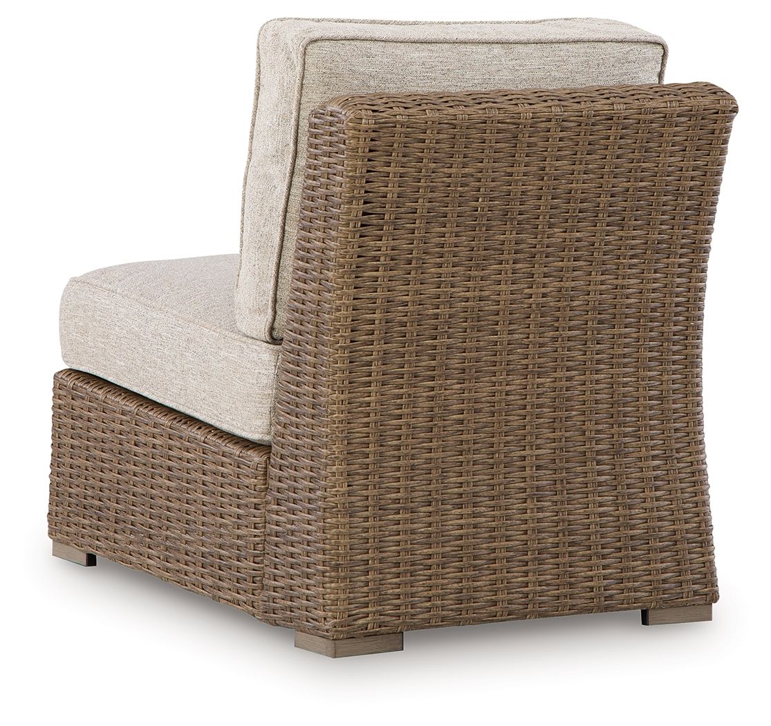 Beige armless chair with seat cushion and upright back, woven wicker frame