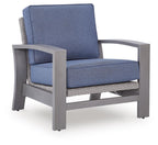 Blue upholstered spring lounge chair with gray frame and padded seat and back cushions