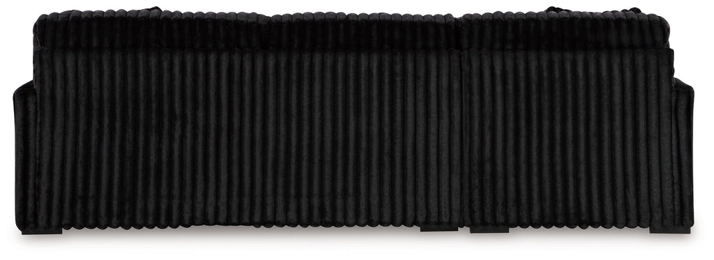 Black corduroy sectional sofa with ribbed back cushions and straight base