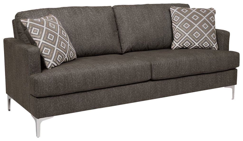 Arcola sofa with dark gray upholstery and patterned throw pillows on back