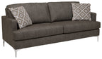Arcola sofa with dark gray upholstery and patterned throw pillows on back