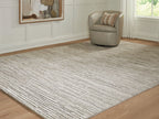 Gray area rug with textured striped pattern and low, flat pile surface