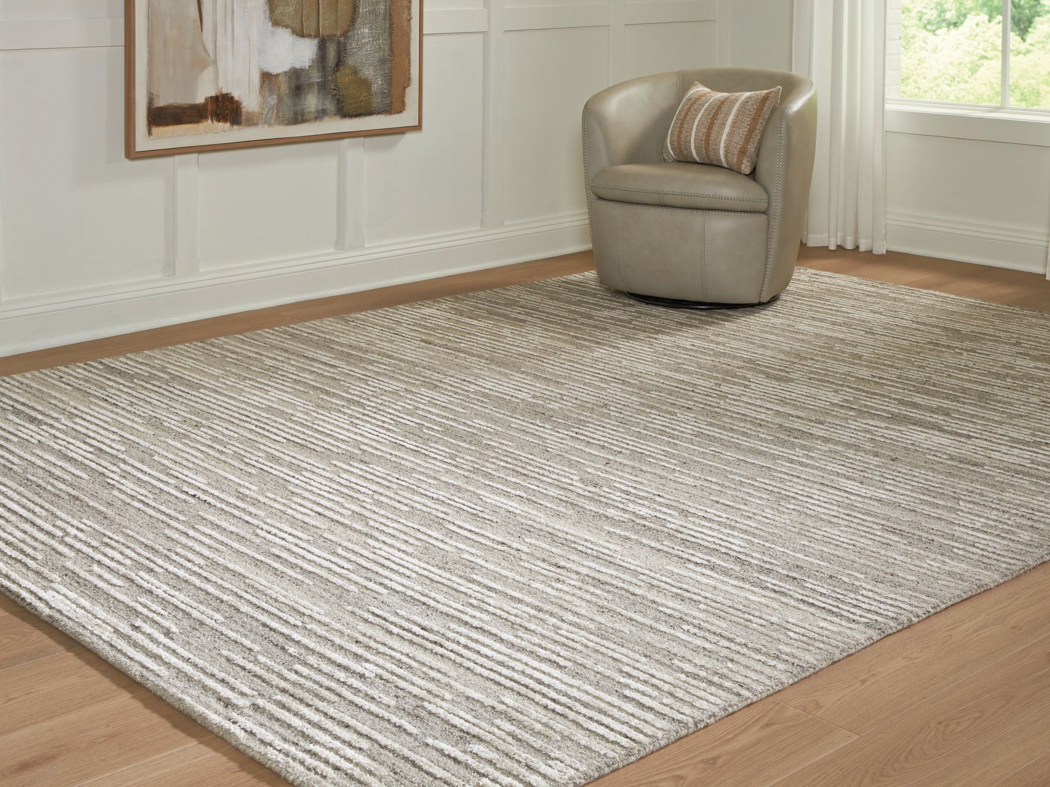 Gray area rug with textured striped pattern and low, flat pile surface