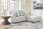 Light gray corduroy-style reclining sectional sofa with chaise and stacked back pillows