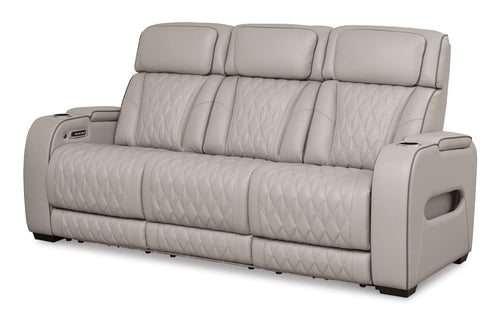 Gray power reclining sofa with padded headrests and diamond-quilted seat back