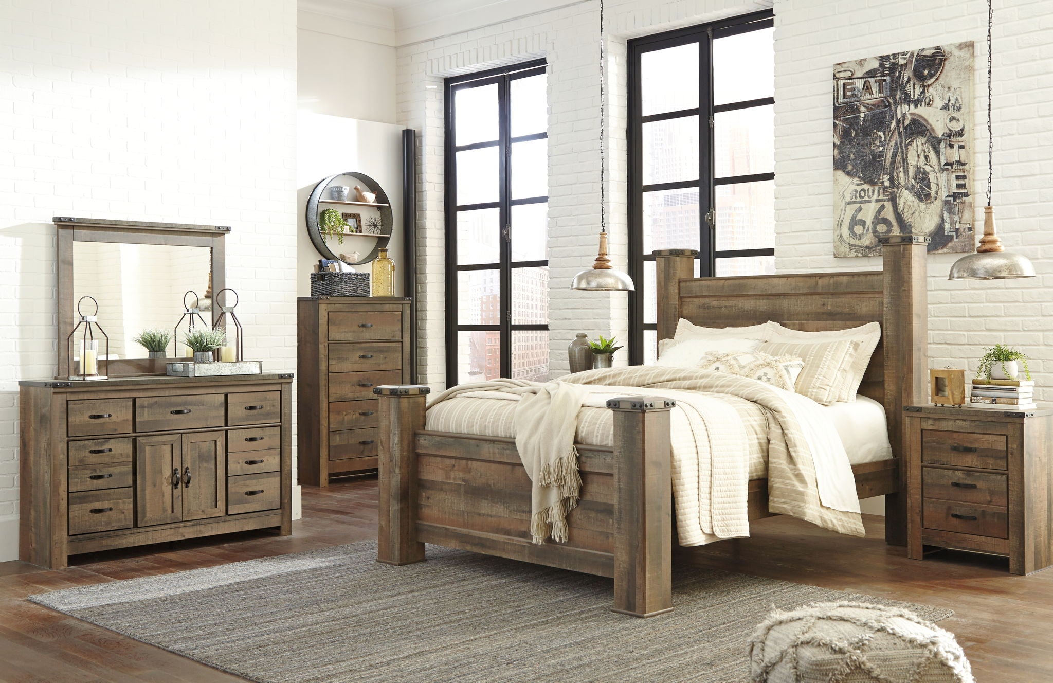 Dark brown poster bed with white quilted comforter and pillows, four posts
