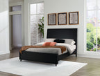 Black panel bed with gray blanket, white sheet, and orange accent pillow
