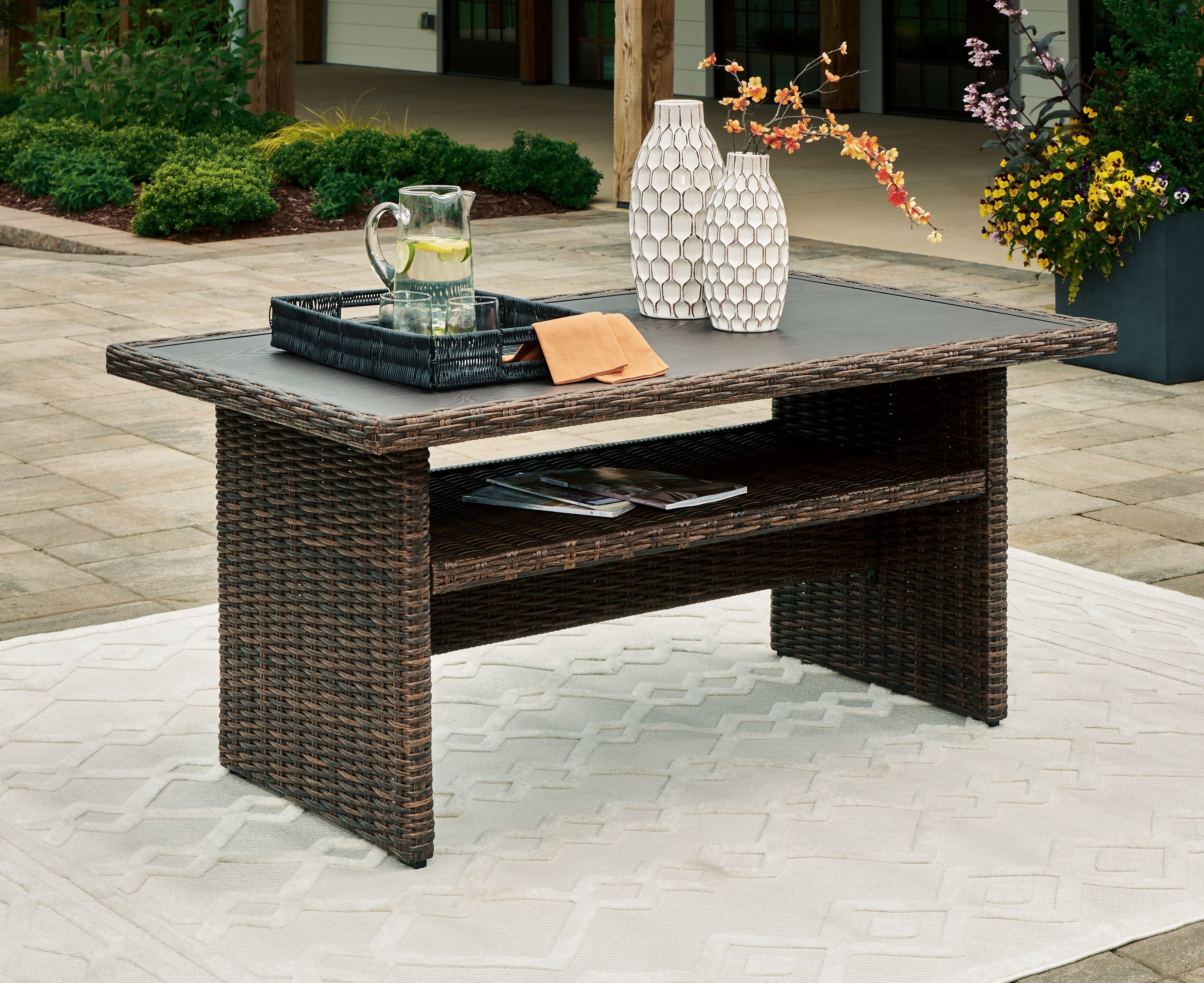 Brown rectangular outdoor table with open lower shelf