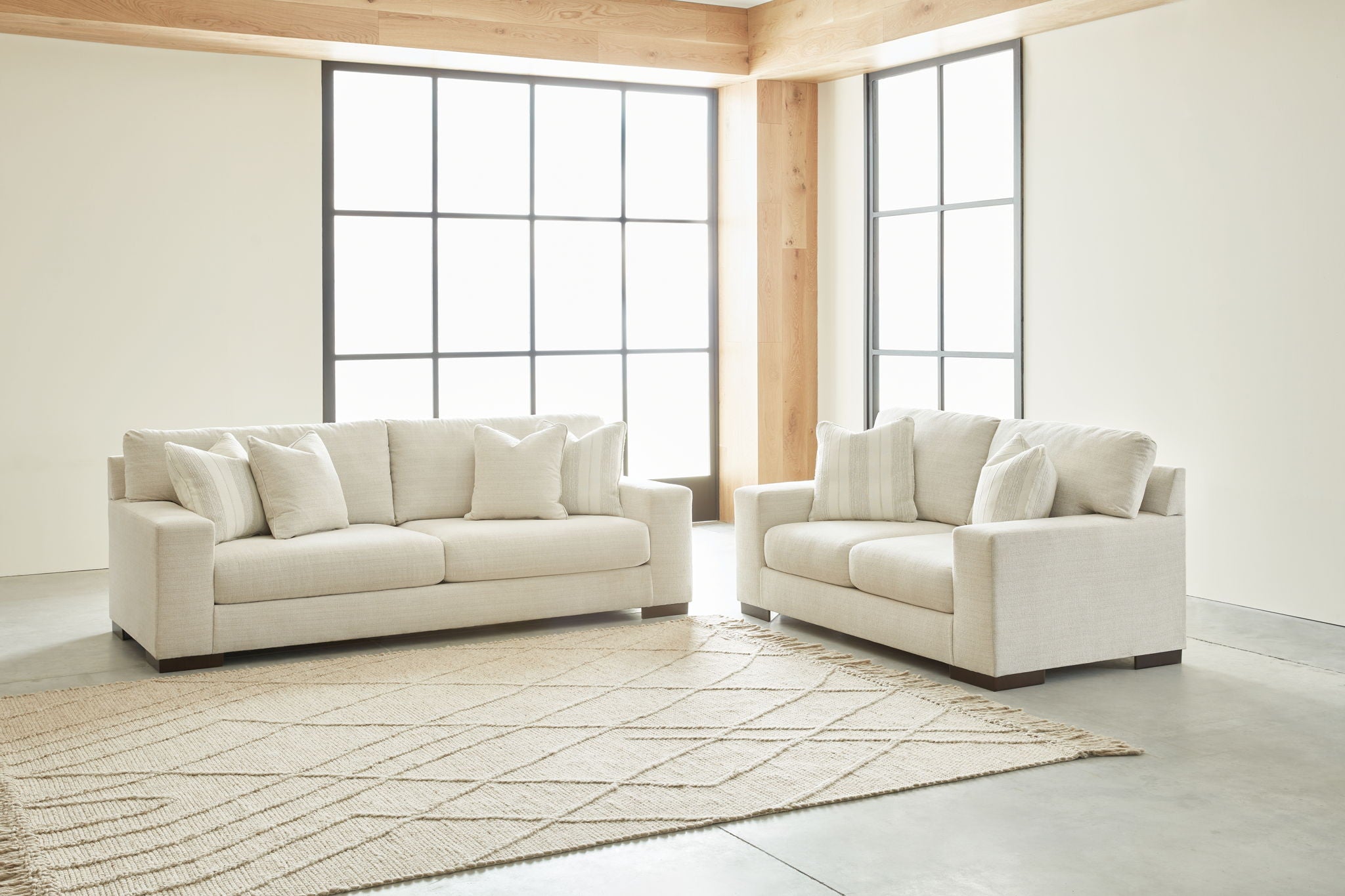 Light beige living room set with two sofas and matching throw pillows