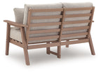Driftwood loveseat with light gray cushions and slatted backrest, plus two patterned pillows.