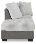 Corner chaise armchair with ribbed light seat, textured back pillows, and dark base
