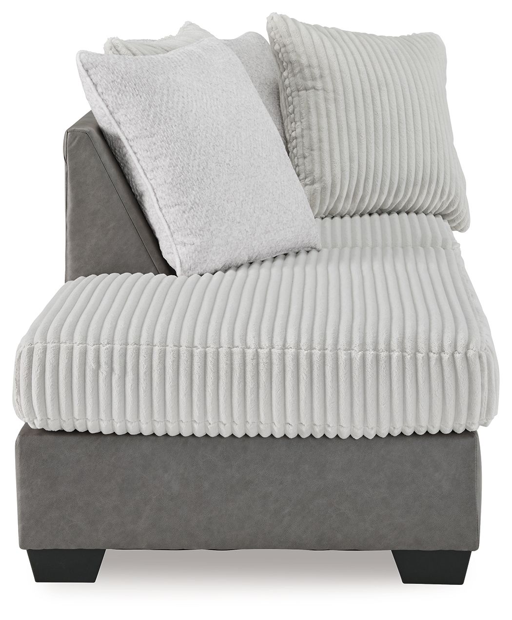 Corner chaise armchair with ribbed light seat, textured back pillows, and dark base