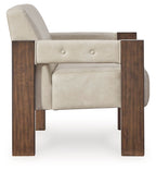 Beige accent chair with dark wood frame, button-tufted back, and side arm rests