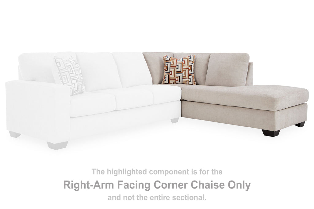 Light stone sectional corner chaise with two geometric pillows and dark legs