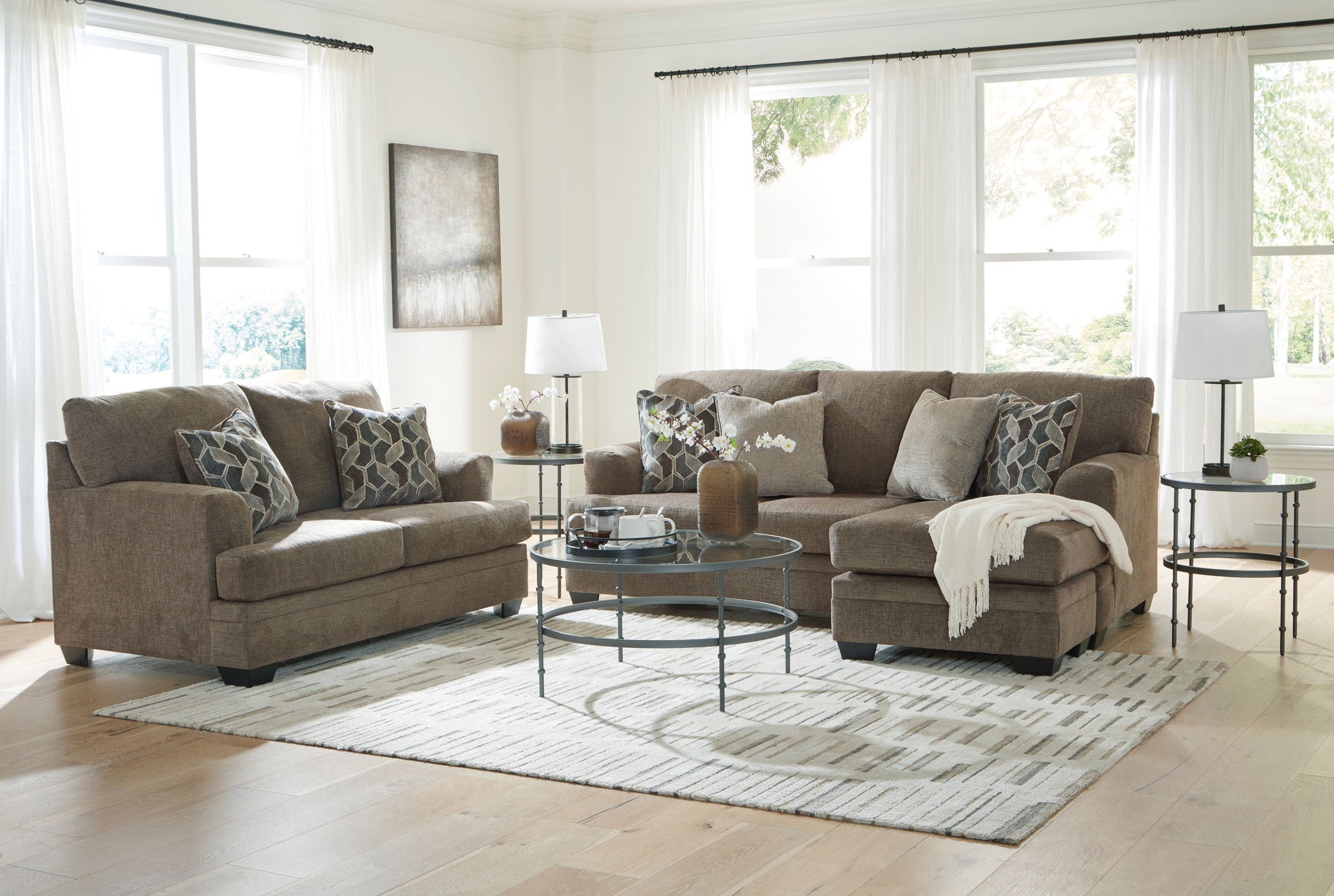 Taupe fabric living room sectional set with chaise, sofa, ottoman, and throw blanket