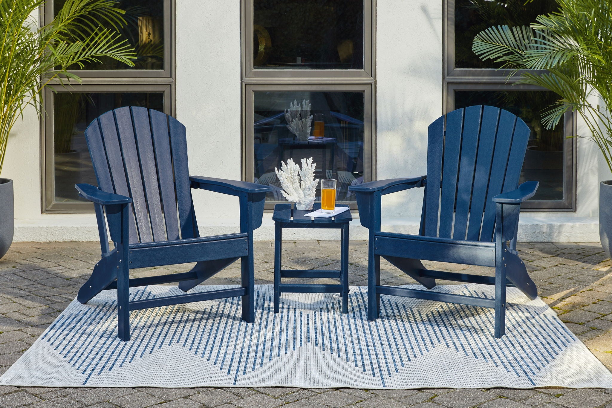Blue outdoor conversation set: two Adirondack chairs with a matching side table