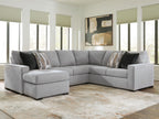 Light gray sectional sofa with chaise and dark and striped throw pillows